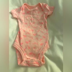 Pink dinosaur onesie